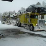 Customer Service yellow auto carrier truck in winter